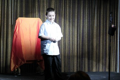 Young boy Dominic helps with a card trick.